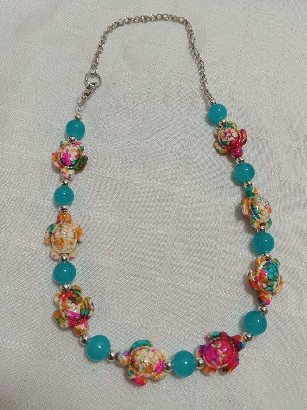 Pretty handmade necklace with  little turtles and glass bead